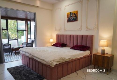 a bedroom with a large bed in a room at Gaikar Farm & Resort in Murbād