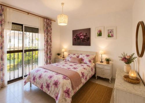 a bedroom with a bed and a window at Terrasol Zayamar in Caleta De Velez