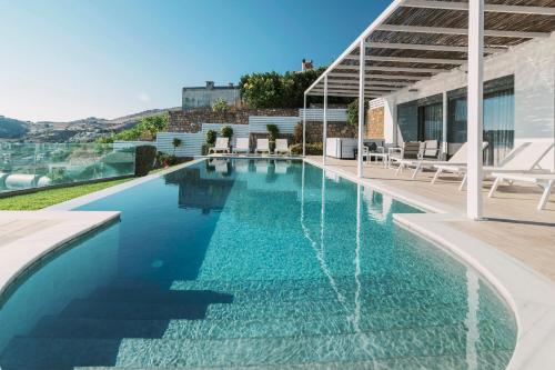 a swimming pool with blue water in a house at Cavo Lindos Villas in Lindos