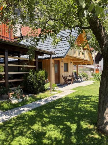 a house with a tree in the yard at Princess Mojca Holiday House in Bled