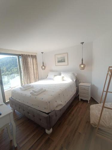 a bedroom with a bed and a window at Korina Studios in Paleokastritsa