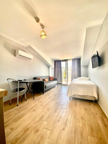 a bedroom with a bed and a desk at Sayar Apart in Marmaris