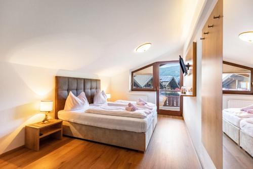 a bedroom with a large bed and a window at Apartment - Ferienwohnung Elisabeth in Radstadt