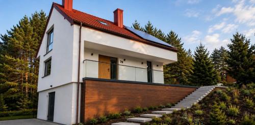 a house with a red roof and a brick wall at DARESTATE - dom rodzinny in Zgon