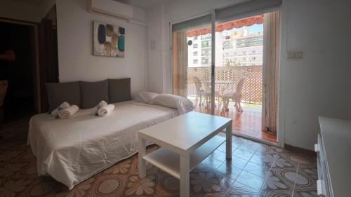 a bedroom with a bed and a table and a window at Luisa in Malgrat de Mar