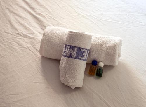 a towel and some medicines on a bed at Luisa in Malgrat de Mar