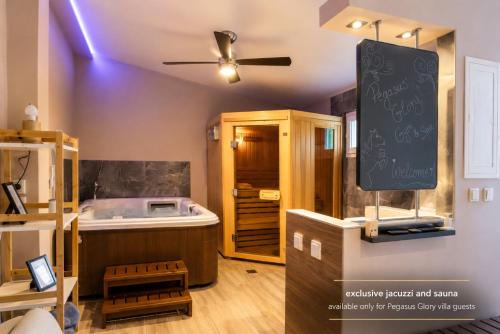 a kitchen with a tub and a sign on the wall at Pegasus Pool Villas Kavala in Kavála