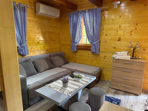 a living room with a couch and a table at Etno kutak Milojevic in Paraćin