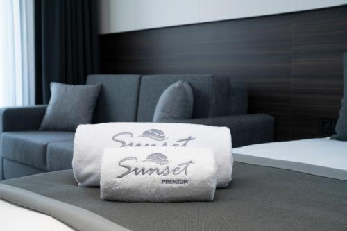 a pillow sitting on a bed next to a couch at Sunset Premium in Keramoti