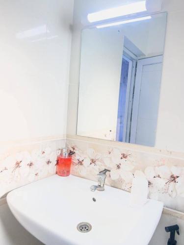 a bathroom with a white sink and a mirror at The palace001 in Mombasa