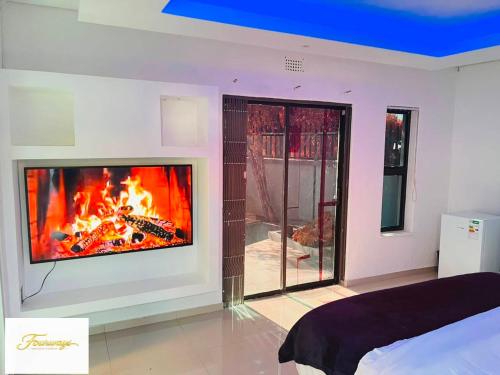 a living room with a fireplace in the wall at Fourways Executive Residence in Four Ways