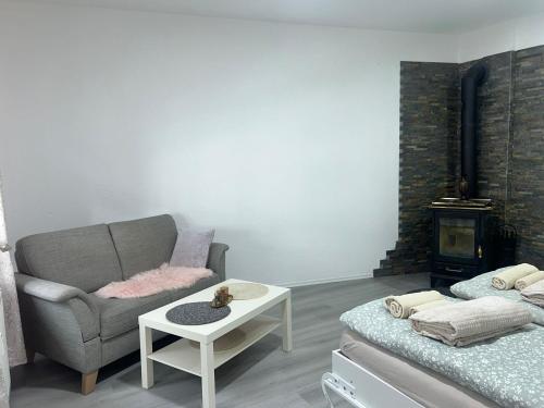 a living room with a couch and a chair and a table at Schöne Ferien- und Monteurwohnung in Ennepetal