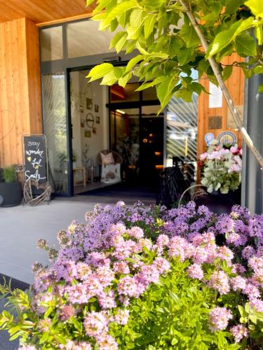 a bunch of purple flowers in front of a building at Apart & Suiten Hotel WEIDEN in Schladming