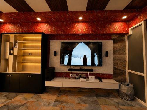 a bathroom with a television on a red wall at weston Hotel And Resorts in kolkata