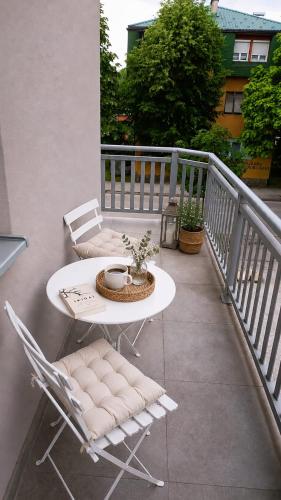 a balcony with a table and chairs on a balcony at Apartment SAYA in Banja Luka