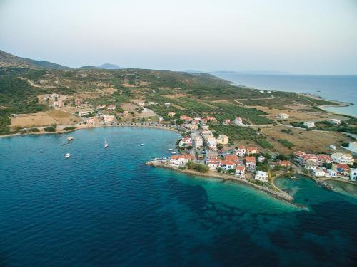 an aerial view of a small island in the water at Lakonia Bay Apartments in Archangelos