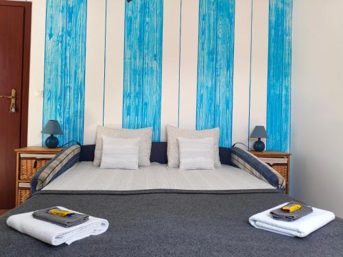 a bedroom with a bed with two towels on it at Sorompó Vendégház in Balatonkenese