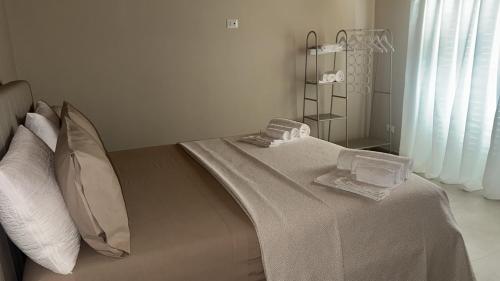 a bedroom with a bed with two towels on it at La piccola Balilla in Venosa