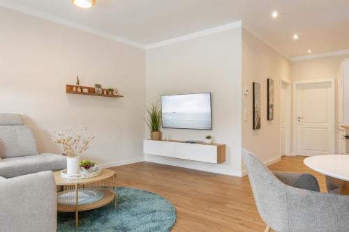 a living room with a couch and a table at Mellenthin-Lodges "Seeigel" in Fehmarn