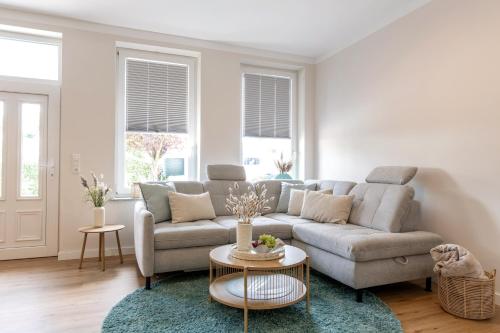 a living room with a couch and a table at Mellenthin-Lodges "Seeigel" in Fehmarn