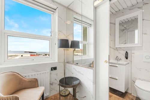 a bathroom with a window and a sink and a toilet at Hotel Keflavik by Reykjavik Keflavik Airport in Keflavík