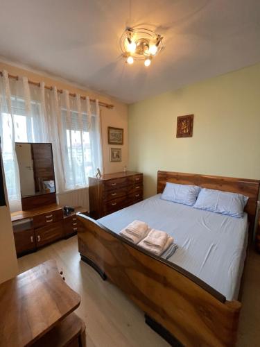 a bedroom with a bed with two towels on it at Lake View Apartment in Pogradec