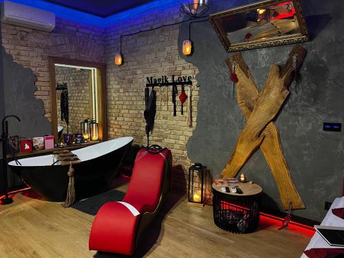 a bathroom with a bath tub and a claw foot bath tub at Magik Love Apartament in Piła