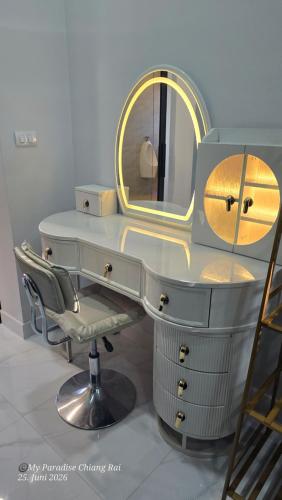 a dressing table with a mirror and a chair at My Paradise Boutique Eco Resort Chiang Rai in Chiang Rai
