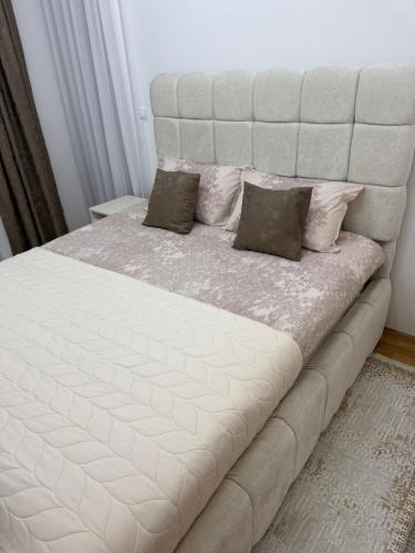 a large white bed with two pillows on it at Stan na dan Alex in Bijeljina