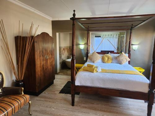 a bedroom with a large bed with a wooden frame at Villa Mexicana Guesthouse in Kimberley