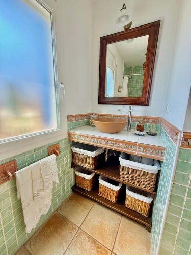 a bathroom with a sink and a mirror at Casa Marvista - piscina, barbacoa y vistas al mar in Pineda de Mar