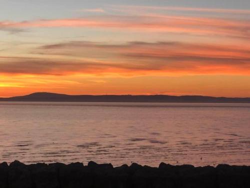 a sunset over a large body of water at Sunsets, Sandylands Prom Morecambe in Morecambe