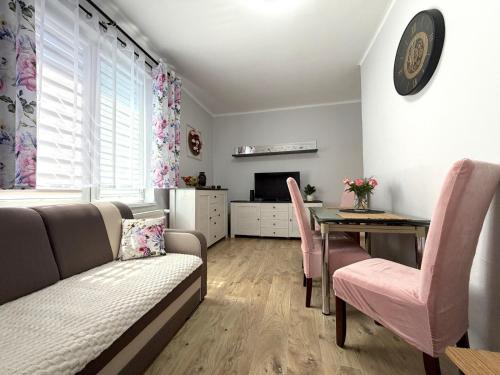 a living room with a couch and a table at Apartament Solankowa Róża in Inowrocław