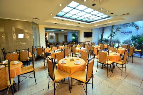 a restaurant with tables and chairs in a room at Oxford Hotel in Montevideo