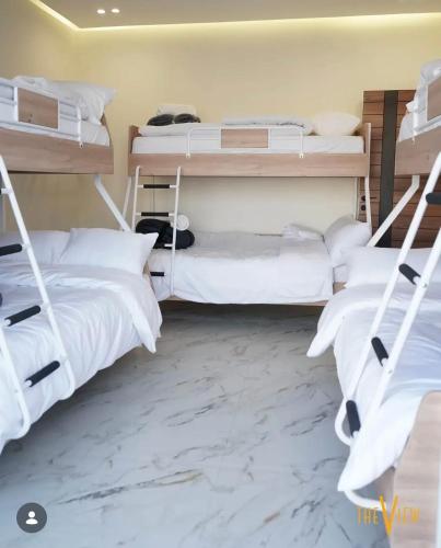 two bunk beds in a room with marble floors at THE VIEW chalet in Makhrabā