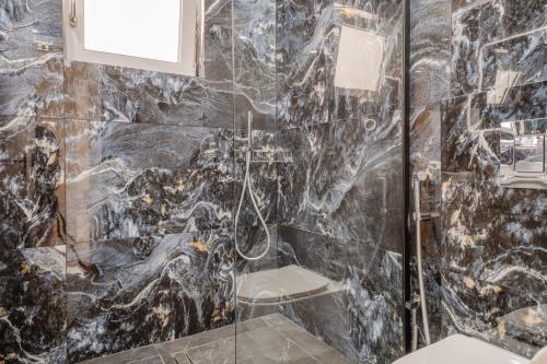 a bathroom with a glass shower with a toilet at Seamar View Zante in Argassi