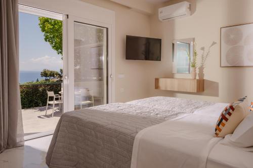 a bedroom with a bed and a view of the ocean at Seamar View Zante in Argassi