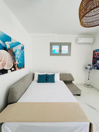a bedroom with a large white bed in a room at Santana Apartments in Perivolos