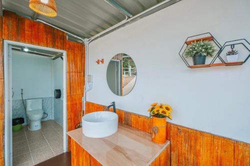 a bathroom with a sink and a mirror at ชิวชิวแคมป์ ภูชี้ฟ้า in Ban Huai Han