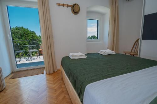 a bedroom with a large bed and a large window at More Garden in Opric