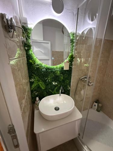 a bathroom with a sink and a mirror at Apartman Marković in Meljine