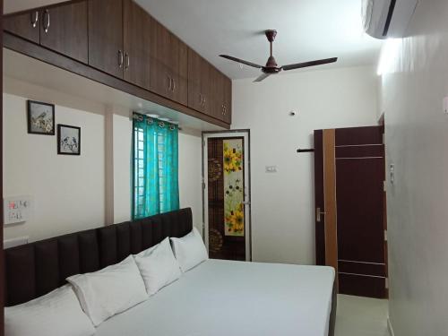 a bedroom with a bed and a ceiling fan at Shanmikha Residency - Attur - Near Highways in Āttūr