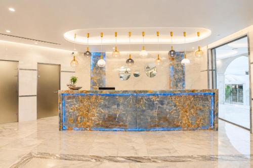 a lobby with a blue marble counter in a building at Kalithea Horizon Blu - Adults Only in Kallithea Rhodes