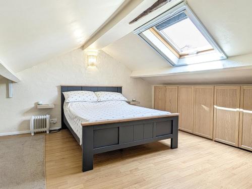 a bedroom with a large bed with a skylight at Bluedothotels location France in Magnac-Laval