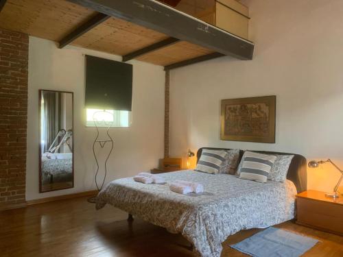 a bedroom with a bed with two stuffed animals on it at Camere con piscina Tenuta BRICCHETTO in Castagneto Po