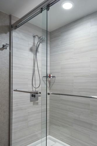 a shower stall with a glass door in a bathroom at Atlanta Marriott Peachtree Corners in Norcross