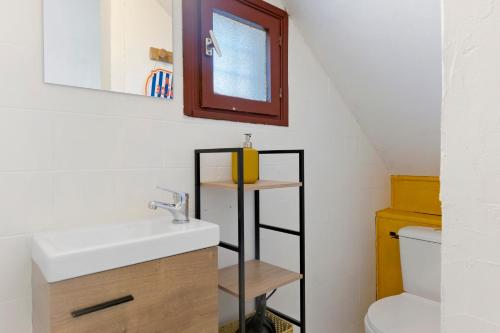 a bathroom with a sink and a mirror and a toilet at O Sole Mio Zen Haven in Valras-Plage