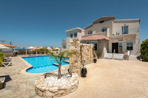 a resort with a swimming pool and a building at Solimar Topaz - Adults Only in Tavronitis