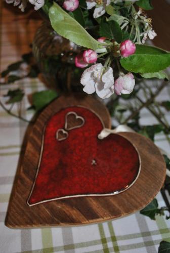 a heart shaped plate on a table with a vase at Prentnergut in Hinterstoder