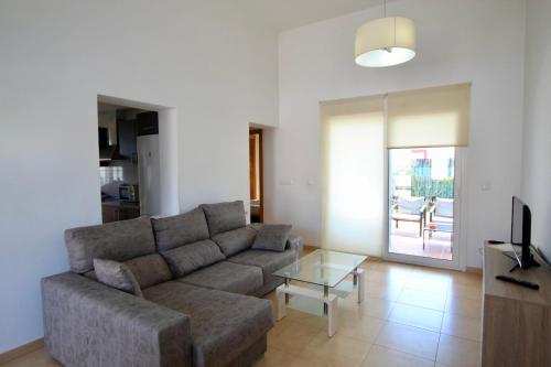 a living room with a couch and a glass table at Casa Morera by Rental Olé in Torre-Pacheco
